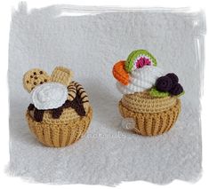 two small crocheted cupcakes sitting next to each other