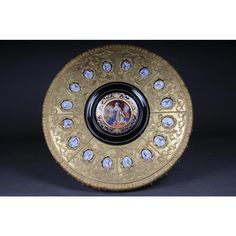 a gold plate with an image of the virgin mary on it