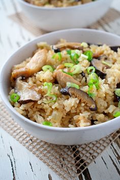 two white bowls filled with rice and vegetables