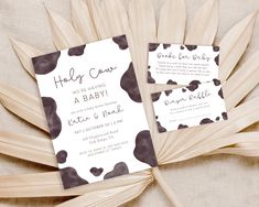 the wedding stationery is laid out on top of palm fronds