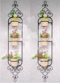 three tiered wall planter with flowers on each shelf