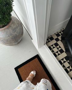 a person standing on the floor in front of a door with their feet propped up