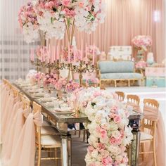 a long table with pink and white flowers on it