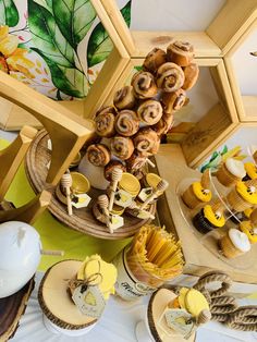 a table topped with lots of different types of pastries and desserts on top of wooden trays