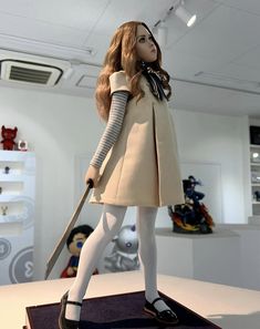 a doll is standing on top of a table