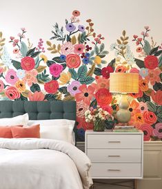 a bedroom with flowers painted on the wall