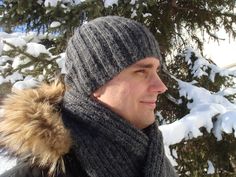 a man wearing a hat and scarf in the snow