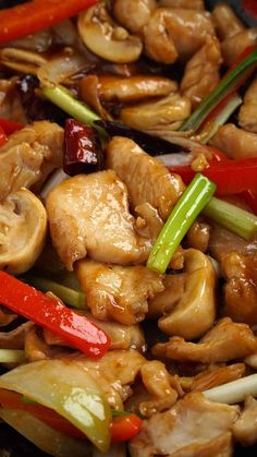 chicken and peppers stir fry in a wok