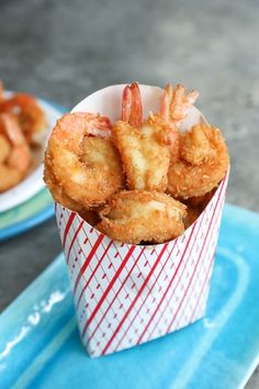 there are some fried shrimp in a paper cup