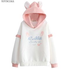 Introducing the adorable kawaii Rabbit Hoodie! This cute hoodie is perfect for those who love everything rabbit-related. Featuring a cute "Rabbit" graphic on the front, this hoodie is sure to make you stand out in a crowd. The hoodie also has two soft and fluffy rabbit ears on top for an extra touch of cuteness. Made from high-quality cotton, this hoodie is both soft and comfortable to wear, making it perfect for everyday use. The hoodie comes in two beautiful pastel colors - pink and blue - so Bunny Ear Hoodie, Rabbit Hoodie, Fairy Kei Fashion, Bunny Hoodie, Kei Fashion, Kawaii Harajuku, Pink Rabbit, Cute Hoodie, Style Hoodie