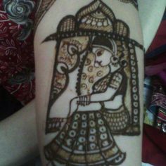 a woman's arm is decorated with hendix and an image of a man