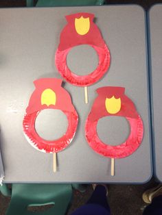 three red paper plates sitting on top of a table with toothbrushes in them