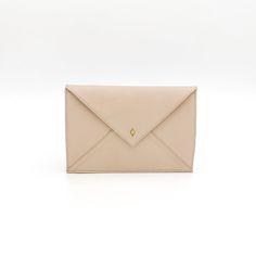 The Envelope Slim Mini has all the benefits of the Envelope Slim Clutch but in a mini size! With wristlet and crossbody strap options, it's perfect for carrying all your essentials no matter what the day brings!Handcrafted in full-grain leather with solid brass hardware. Complete with an outside pocket, inner pockets for a cellphone and credit cards, and a removable shoulder strap.Ways To Wear Wear it as a clutch or as a shoulder bag Easily fits your phone, keys, credit cards, and lipgloss Has i Chic Envelope Wallet For Everyday Use, Minimalist Envelope Wallet For Daily Use, Beige Envelope Wallet For Everyday Use, Minimalist Envelope Clutch For Everyday Use, Everyday Envelope Clutch With Card Slots, Minimalist Everyday Envelope Bag, Minimalist Envelope Bag For Everyday, Classic Envelope Wallet, Beige Envelope Clutch For Everyday Use