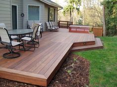 a wooden deck with chairs and tables on it