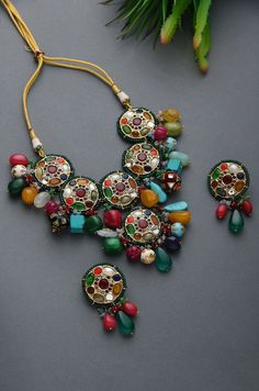 Multicoloured Navrattan Kundan Inspired Necklace with Earrings. This beautifully handcrafted necklace is set in silver and copper alloy and plated with 22k gold. This necklace with a twist of Pearl stones by Paisley Pop is a perfect accessory for an Indian Bride. LENGTH Necklace Size - Length 16 inches Closure - Adjustable Thread Dori DETAILS -100% top Quality Faux Glass Polki -22K gold and silver Plated silver copper alloy. -Handcrafted in our all girls workshop in Paisley Pop Studio, Jammu and Indian Jewelry Earrings, Antique Jewellery Designs, Jewelry Set Design, Antique Jewelry Indian, Wedding Jewellery Collection, Indian Jewelry Sets, Chunky Jewelry, Choker Set, Jewelry Design Earrings