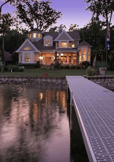 a large house sitting next to a body of water