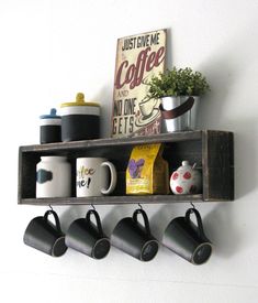 a shelf with coffee cups and mugs on it