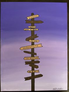 a sign post with many signs pointing in different directions on the same pole against a purple and blue sky