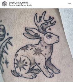 a tattoo with a deer and stars on it