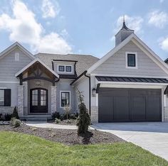 a large house with two garages on the front