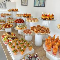 a table filled with lots of different types of desserts and pastries on it