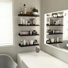 a white table with two mirrors and some shelves on the wall in front of it