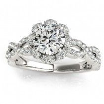 a white gold engagement ring with an intricate halo setting and round brilliant cut diamonds on the band