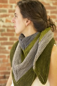 a woman wearing a knitted hat and scarf with the words new brain written on it