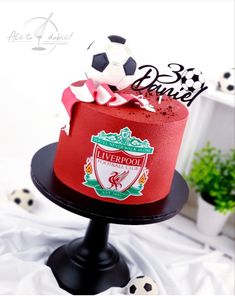 there is a red cake with a soccer theme on it