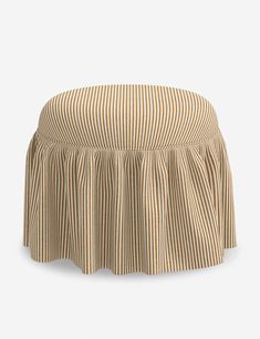 a tan and white striped ottoman cover with pleated edges on an isolated background,