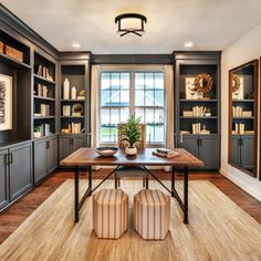 a dining room with built in bookshelves and wooden floors