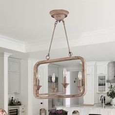 a chandelier hanging from the ceiling in a kitchen