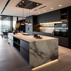 a modern kitchen with marble counter tops and black cabinetry, along with wooden flooring