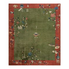 a green rug with flowers and birds on it