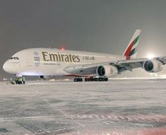 an airplane is sitting on the runway at night