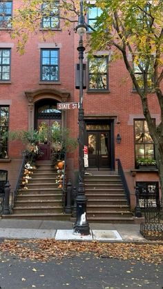 an apartment building with stairs leading up to the front door