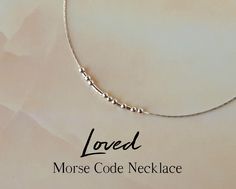 "This delicate sterling silver necklace spells the word \"Loved\" in Morse code, as a secret reminder of a loving bond. A meaningful piece of jewelry that will make a delightful gift for any of your loved ones, friend or family! The word \"Loved\" is spelled in Morse code using round sterling silver beads representing the dots, and sterling silver tubes as the dashes. The necklace will come with a card displaying the message in both Morse code and English. ABOUT THE MATERIALS: - The sterling sil Secret Message Jewelry, Code Morse, Morse Code Necklace, Message Necklace, Necklace For Mom, Morse Code Bracelet, Hidden Message, Handmade Jewelry Tutorials, Jewelry Dainty