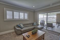 a living room filled with furniture and a sliding glass door leading to an outside patio