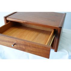 a wooden desk with two drawers and one drawer open to show the inside of it