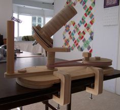 a table that has some kind of wooden object on top of it and is sitting in front of a door