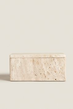 an object made out of marble sitting on top of a white surface with no one around it