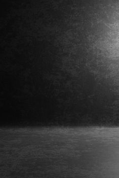 a black and white photo of a man holding a tennis racket