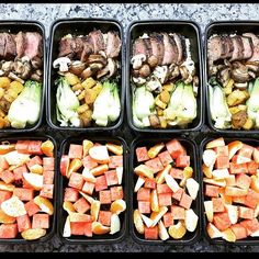 four trays filled with different types of food on top of a stone countertop