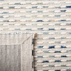 a close up view of the fabric on a wall with blue and white stripes in it