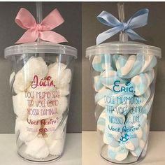 two plastic cups filled with marshmallows and one has a bow on the top