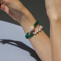 A True Favorite, the Green Onyx Bracelet is bold and elegant. A rich green faceted onyx is complemented by our lustrous white baroque pearls, symbolizing the balance between contemplative peace and a lust for adventure. Green Onyx is known for its powerful energy in blocking negativity and creating contagious confidence. Finished with luxurious and durable 14K gold-filled hardware, this bracelet will last through all your journeys. Wear it alone or pair it with an Accent Pearl Green Onyx Bracele Powerful Energy, Onyx Bracelet, Rich Green, Dynamic Design, Green Onyx, Independent Designers Fashion, Baroque Pearls, Hair Products, White Green