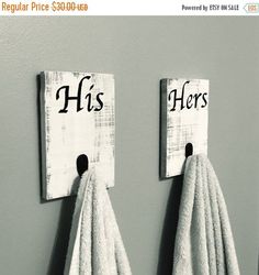 two towels are hanging on the wall next to each other with words written on them