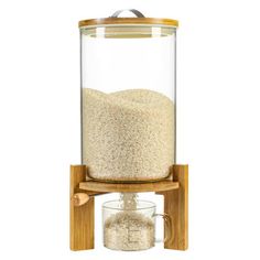 a glass jar with some grain in it and a wooden stand on the side that holds a cup