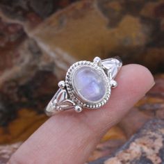 Elevate your style with our stunning Rainbow Moonstone ring. This handcrafted beauty features a mesmerizing Rainbow Moonstone set in a splendid sterling silver ring. *Captivating Colors: The Rainbow Moonstone's iridescent play of colours adds a touch of magic to your look. Each stone is carefully chosen for its unique charm. *Celestial Charm: The sterling silver moonstone setting adds a celestial touch, showcasing the moonstone in an elegant and timeless design. *Handcrafted Beauty: made by skilled artisans, each ring is a work of art that brings a special touch to your style. *Versatile Elegance: Whether for special occasions or everyday wear, this Moonstone ring is a versatile piece that adds a hint of mystique to any outfit. *Perfect Fit: Available in various sizes, ensuring a comfortab Oval Cabochon Moonstone Ring, Oval Moonstone Ring In Fine Jewelry Style, Moonstone Oval Cabochon Ring, Handmade Oval Gemstones For Wedding, Adjustable Oval Topaz Promise Ring, Fine Jewelry Moonstone Rings In Oval Cabochon Shape, Moonstone Oval Cabochon Fine Jewelry Ring, Bohemian Sterling Silver Oval Cabochon Moonstone Ring, Spiritual Moonstone Oval Cabochon Ring