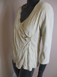 Vintage crushed cotton wrap top in cream\white.  It has half sleeves,  a V neck and the wrap is secured by a large square button on the front . Length: 22 inches. Bust: 36 Inches. Sleeve: 18 Inches. Made in France cotton Cream Linen V-neck Top, Cream Wrap Top For Spring, Spring Cream Wrap Top, Cream Top, Cream Tops, Boho Top, Top Vintage, Casual Top, Cotton Top